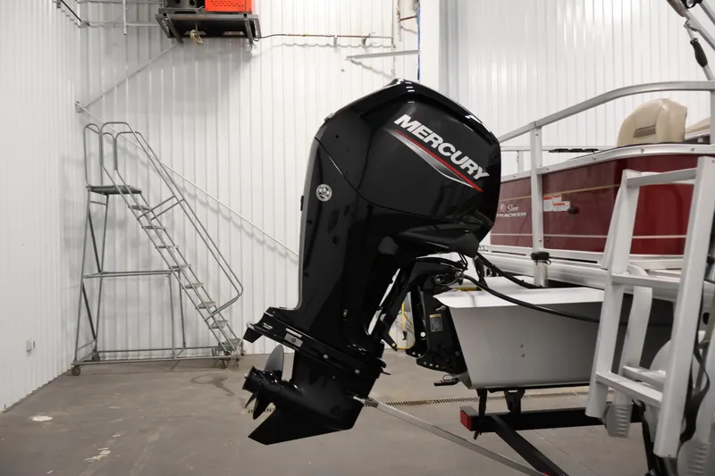 Slide: The Image of 2021 Sun Tracker Bass Buggy 18 DLX with Mercury outboard motor in a garage. - 43