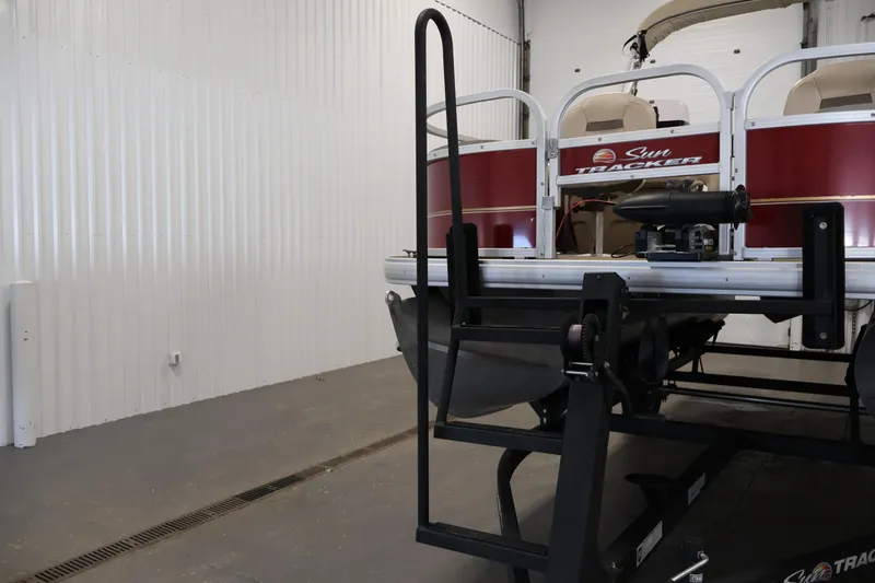 Slide: The Image of 2021 Sun Tracker Bass Buggy 18 DLX pontoon boat in a garage setting. - 46