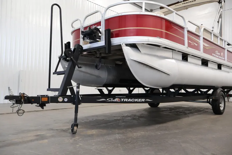Slide: The Image of 2021 Sun Tracker Bass Buggy 18 DLX pontoon boat on trailer in indoor setting. - 47