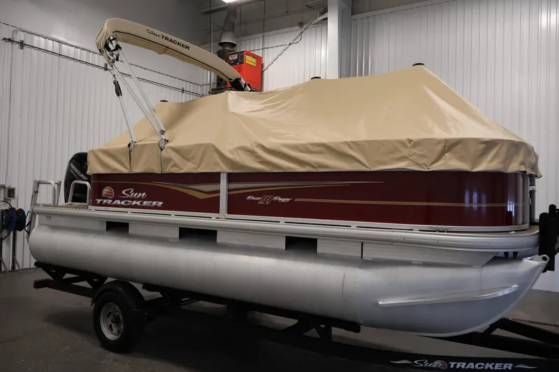 Slide: The Image of 2021 Sun Tracker Bass Buggy 18 DLX pontoon boat with cover in a garage. - 50