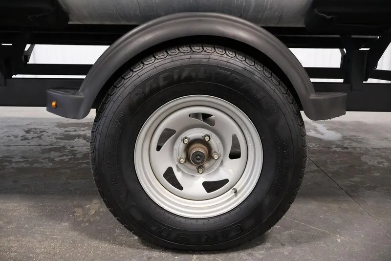Slide: The Image of Trailer wheel of 2021 Sun Tracker Bass Buggy 18 DLX, featuring radial tire and fender. - 51