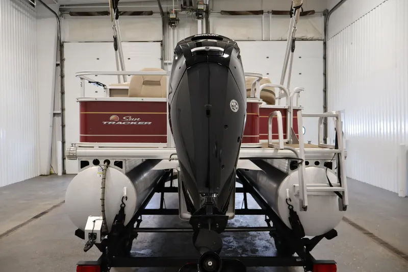 Slide: The Image of 2021 Sun Tracker Bass Buggy 18 DLX pontoon boat in a garage setting. - 6