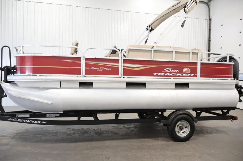 Slide: The Image of 2021 Sun Tracker Bass Buggy 18 DLX pontoon boat in a showroom setting. - 8