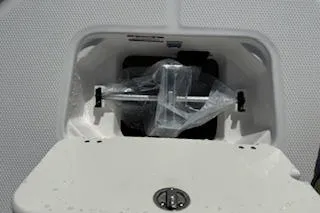Slide: The Image of Storage compartment of 2026 Robalo 206 Cayman boat, featuring secure latch and protective packaging. - 12