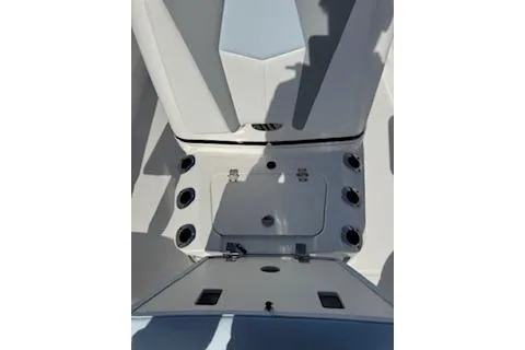 Slide: The Image of 2026 Robalo 206 Cayman boat interior with storage compartment and cup holders. - 14