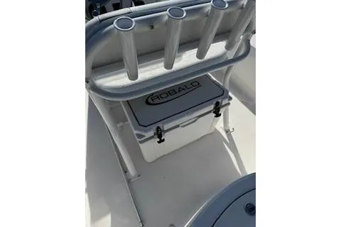 Slide: The Image of 2026 Robalo 206 Cayman boat interior with rod holders and storage compartment. - 23