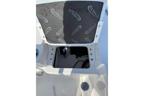 Slide: The Image of 2026 Robalo 206 Cayman boat storage compartment with open hatch. - 26