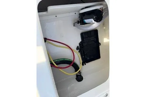 Slide: The Image of 2026 Robalo 206 Cayman boat compartment with wiring and pump system. - 27