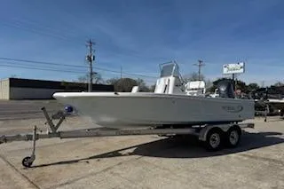 Slide: The Image of 2026 Robalo 206 Cayman boat on trailer, parked outdoors under clear blue sky. - 3