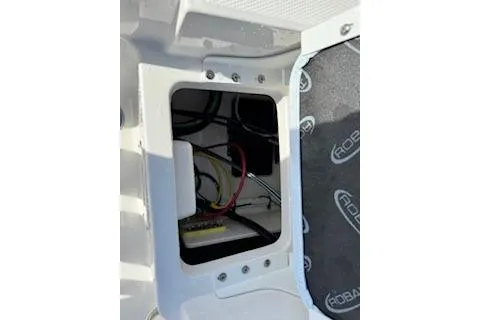 Slide: The Image of 2026 Robalo 206 Cayman boat wiring compartment with visible cables and components. - 31