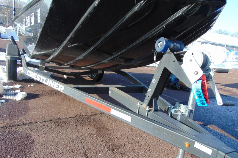 Slide: The Image of 2020 Crestliner 1600 Storm boat on trailer, parked on snowy pavement. - 10