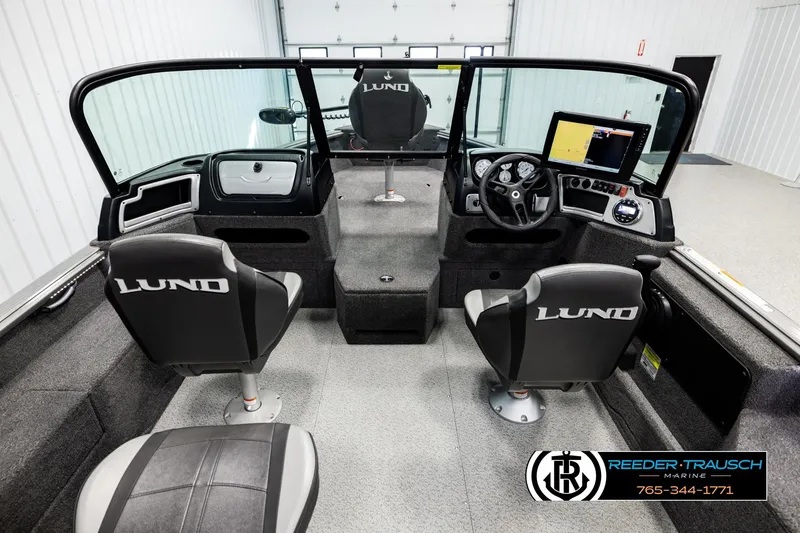 Slide: The Image of 2023 Lund 1875 Impact XS boat interior with steering console and branded seats. - 13