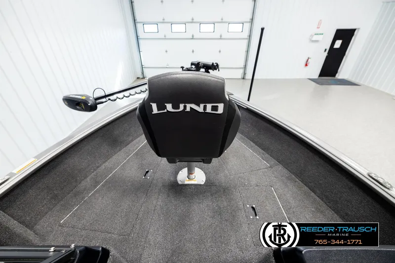 Slide: The Image of 2023 Lund 1875 Impact XS boat interior with branded seat in a showroom. - 14