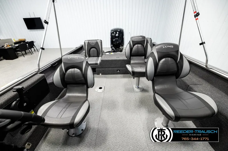 Slide: The Image of 2023 Lund 1875 Impact XS boat interior with four seats in showroom. - 16