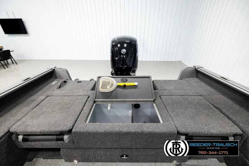 Slide: The Image of 2023 Lund 1875 Impact XS boat interior with storage compartments and motor. - 20