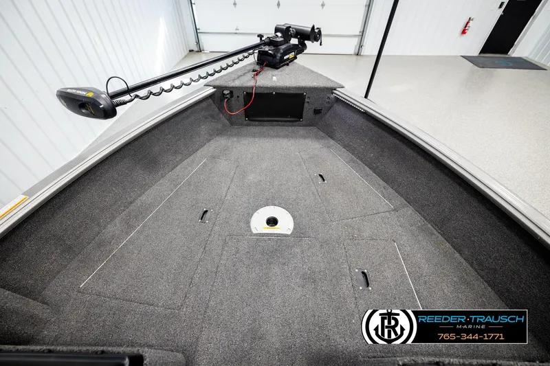 Slide: The Image of 2023 Lund 1875 Impact XS boat interior with trolling motor, spacious deck, and storage compartments. - 21