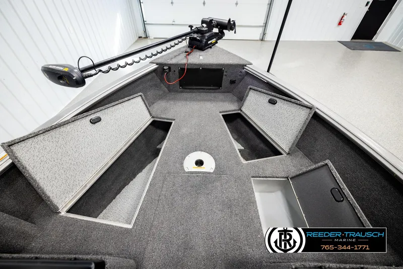 Slide: The Image of 2023 Lund 1875 Impact XS boat interior with storage compartments and trolling motor. - 22