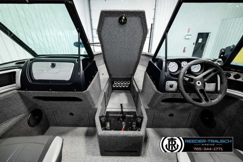 Slide: The Image of 2023 Lund 1875 Impact XS boat interior with steering wheel and dashboard controls. - 24