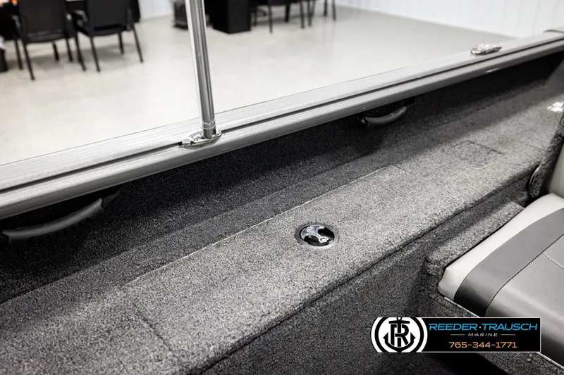 Slide: The Image of 2023 Lund 1875 Impact XS boat interior with carpeted storage and seating. - 25