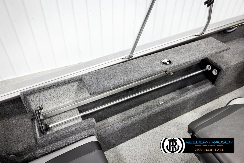 Slide: The Image of 2023 Lund 1875 Impact XS boat interior storage compartment with carpeted finish. - 28