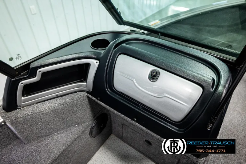 Slide: The Image of 2023 Lund 1875 Impact XS boat dashboard with storage compartment and speaker. - 31