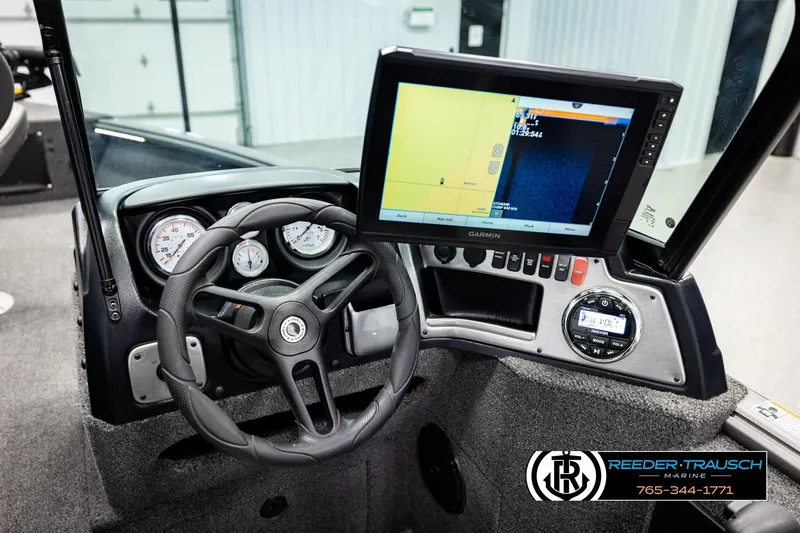 Slide: The Image of 2023 Lund 1875 Impact XS boat dashboard with Garmin navigation system and steering wheel. - 33