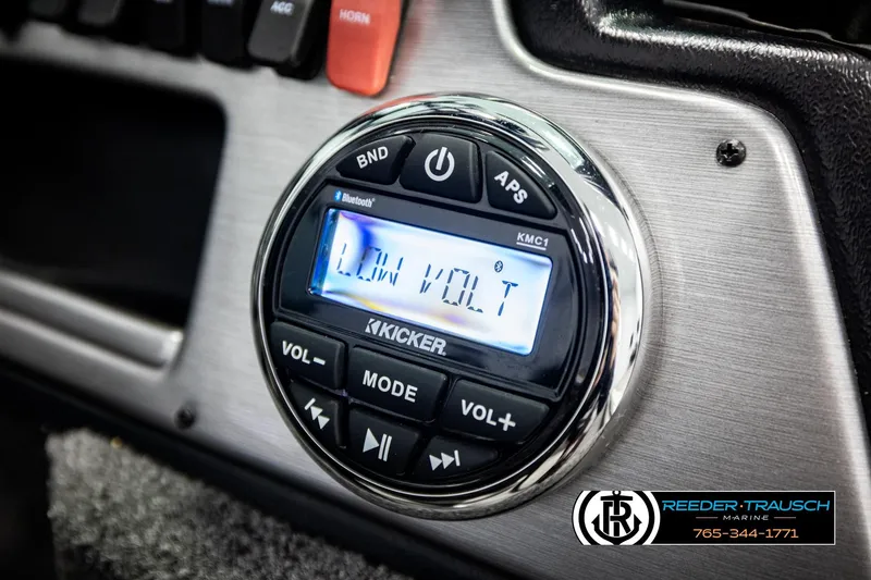 Slide: The Image of 2023 Lund 1875 Impact XS boat dashboard with Kicker audio system displaying "Low Volt." - 37