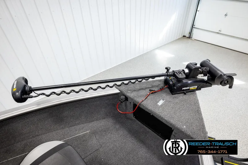 Slide: The Image of 2023 Lund 1875 Impact XS boat with Minn Kota trolling motor in a showroom. - 44