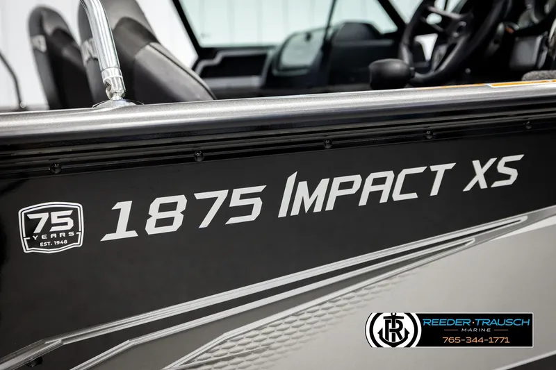 Slide: The Image of 2023 Lund 1875 Impact XS boat, black exterior, Reeder-Trausch Marine logo visible. - 57