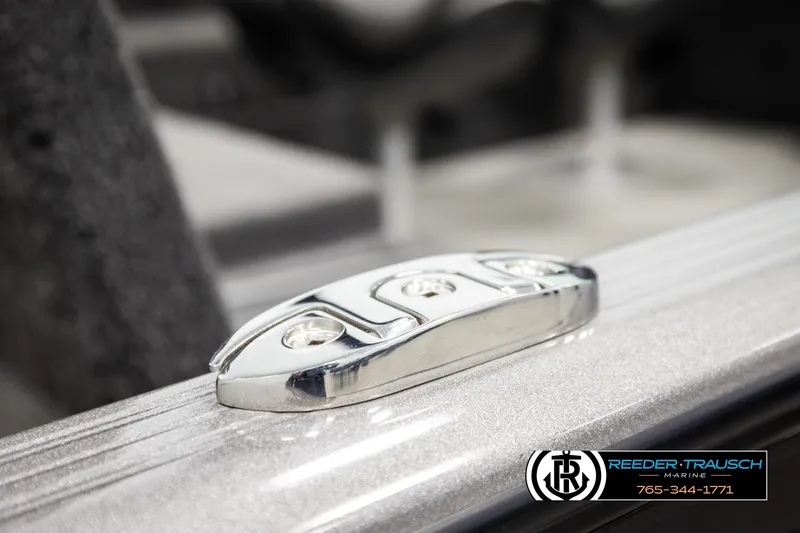 Slide: The Image of Close-up of a 2023 Lund 1875 Impact XS boat cleat, featuring sleek metallic design. - 59