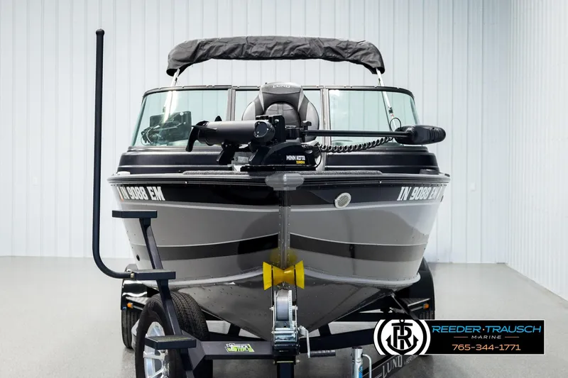 Slide: The Image of 2023 Lund 1875 Impact XS boat on trailer in showroom, front view. - 7