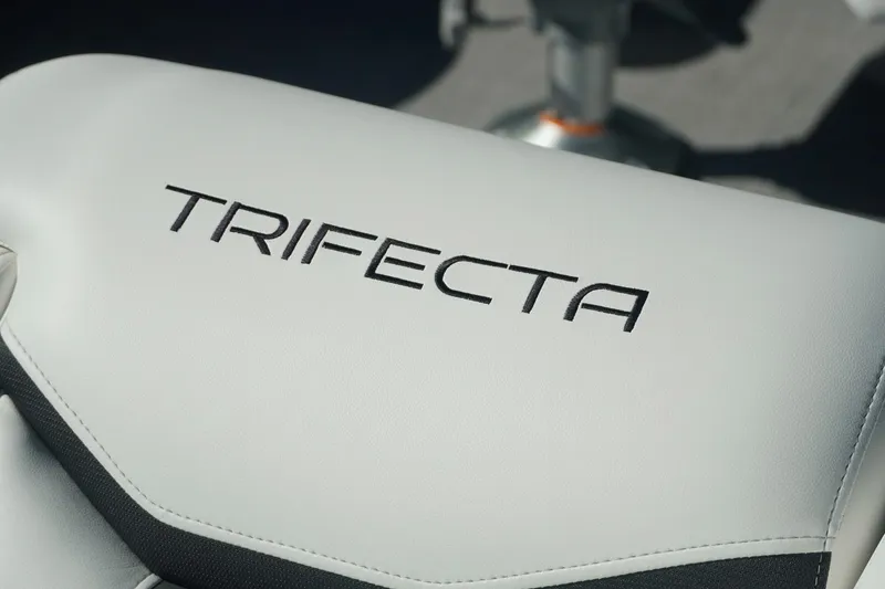 Slide: The Image of 2026 Trifecta 24E CS boat seat with logo, featuring sleek white upholstery. - 18