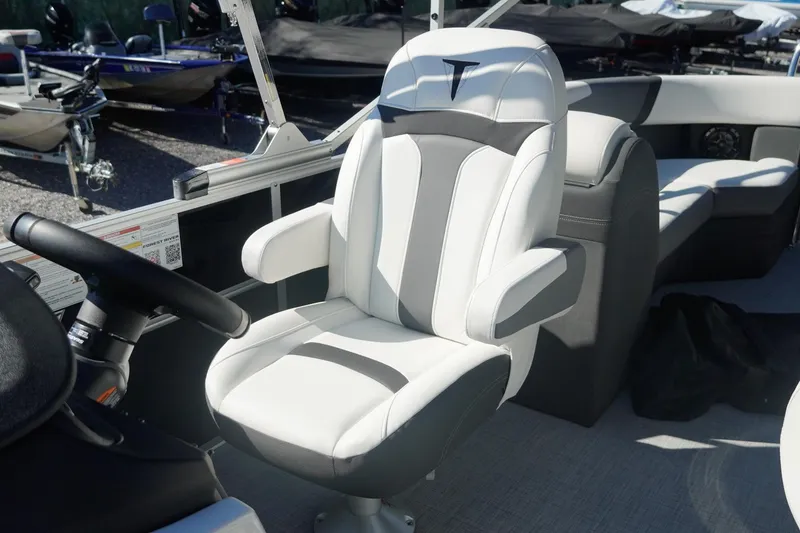 Slide: The Image of Captain's chair on 2026 Trifecta 24E CS boat, featuring sleek white and gray design. - 19