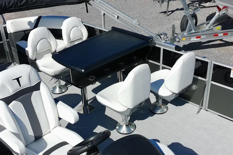 Slide: The Image of 2026 Trifecta 24E CS pontoon boat interior with white seating and black table. - 20