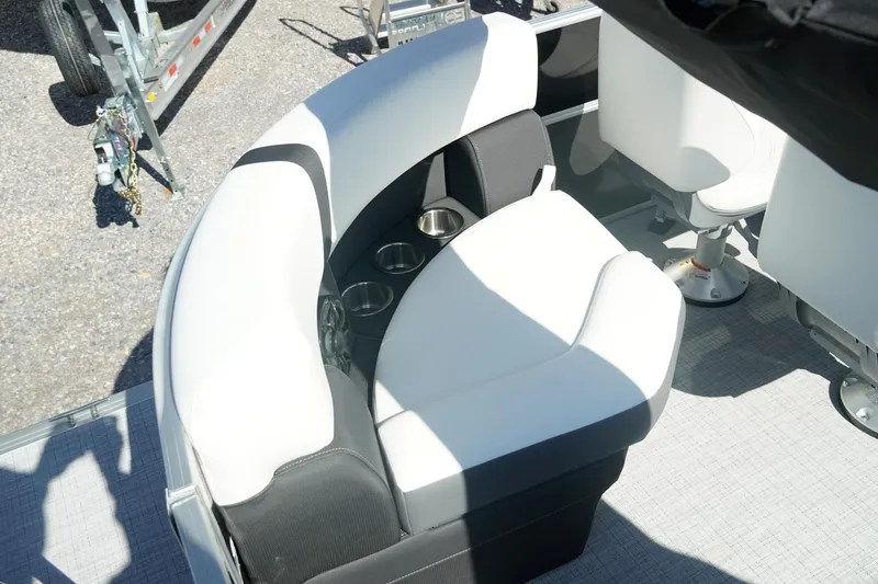 Slide: The Image of 2026 Trifecta 24E CS boat seating with cup holders, featuring modern white and black design. - 24