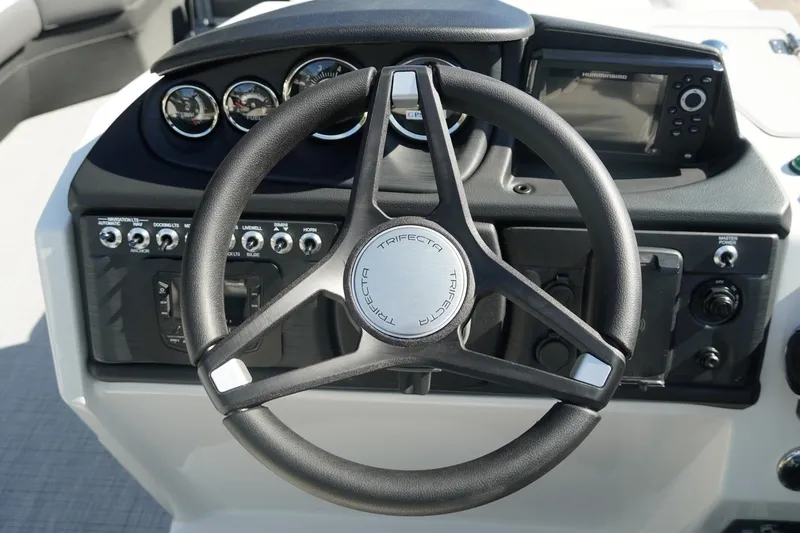 Slide: The Image of Steering wheel and dashboard of 2026 Trifecta 24E CS boat with control panel. - 25