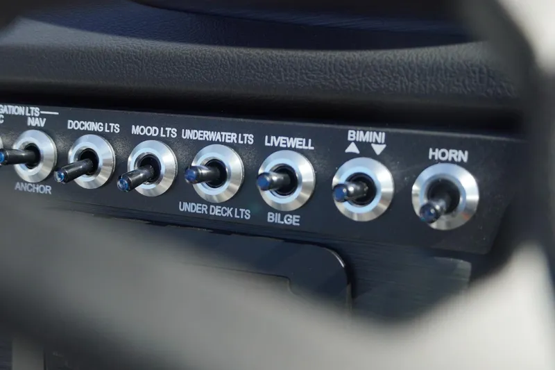 Slide: The Image of Control panel of 2026 Trifecta 24E CS boat with various switches. - 29