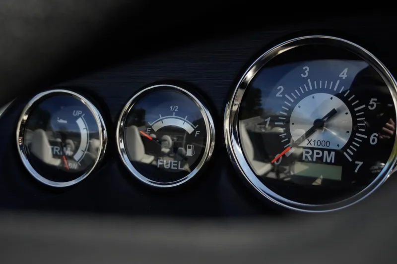 Slide: The Image of Dashboard gauges of 2026 Trifecta 24E CS, showing trim, fuel, and RPM levels. - 30