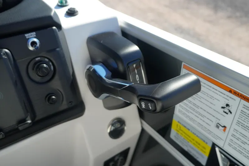 Slide: The Image of Throttle control panel of 2026 Trifecta 24E CS boat with warning labels. - 32