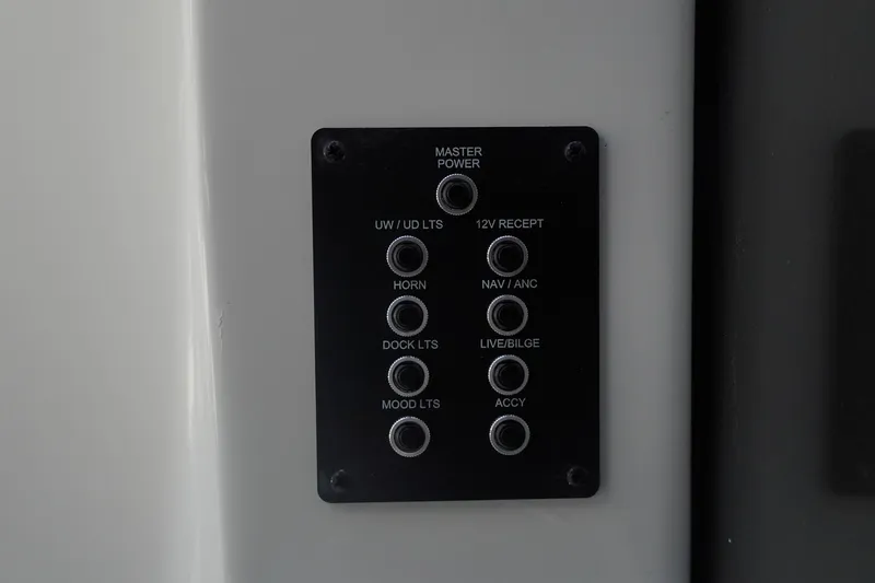 Slide: The Image of Control panel of 2026 Trifecta 24E CS boat with labeled switches. - 34