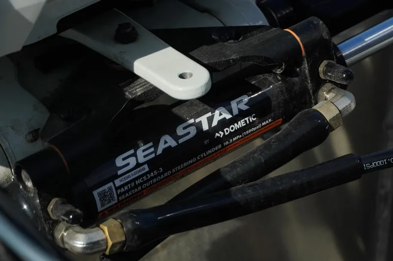 Slide: The Image of Close-up of SeaStar hydraulic steering cylinder on Trifecta 24E CS, 2026 model. - 42