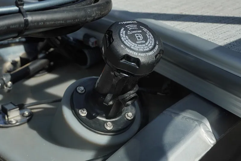 Slide: The Image of Fuel cap of 2026 Trifecta 24E CS boat, featuring Dometic branding and cautionary text. - 43