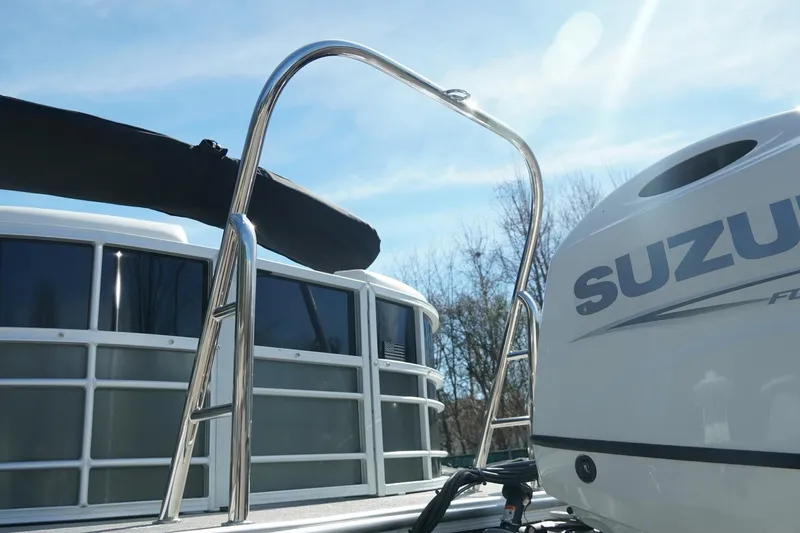 Slide: The Image of 2026 Trifecta 24E CS boat with Suzuki engine, featuring sleek design and sturdy ladder. - 46