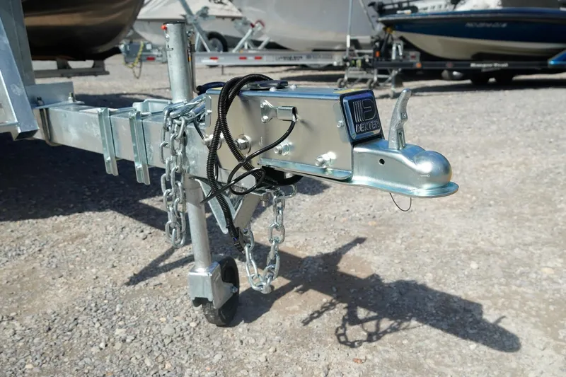 Slide: The Image of Trailer hitch of 2026 Trifecta 24E CS boat, featuring a sturdy metal construction. - 49