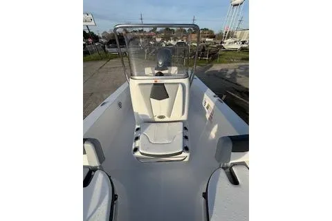 Slide: The Image of 2026 Rabalo 206 Cayman boat interior with console and seating, docked outdoors. - 10