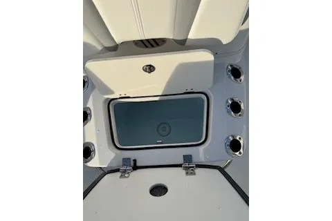 Slide: The Image of 2026 Rabalo 206 Cayman boat storage compartment with rod holders. - 12
