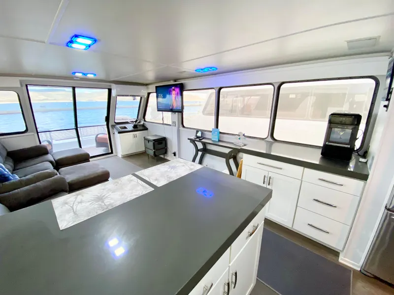 Slide: The Image of Modern interior of 1988 Three Buoys 4412 houseboat with sleek kitchen and lounge area. - 12