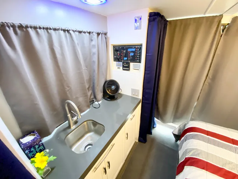 Slide: The Image of Interior of 1988 Three Buoys 4412 with kitchenette and bed, featuring modern amenities. - 21