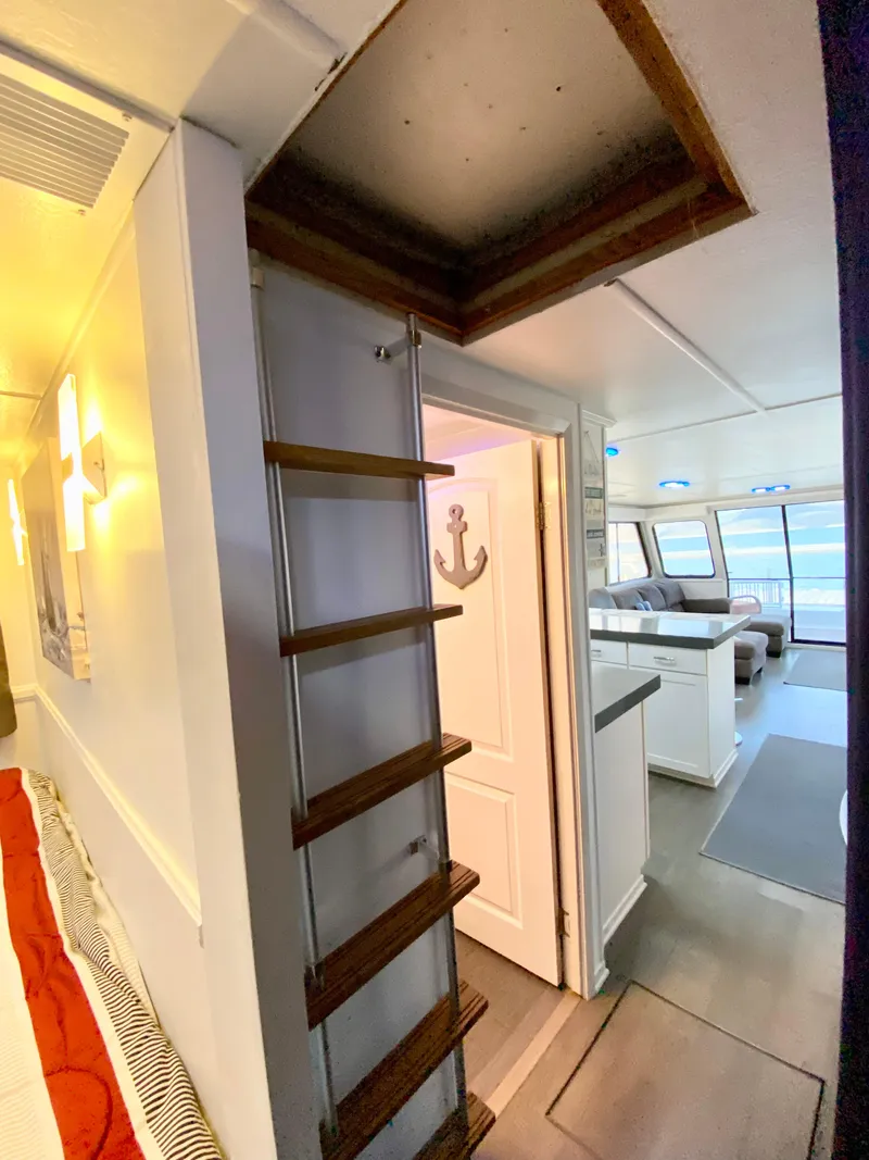 Slide: The Image of Interior of 1988 Three Buoys 4412 boat with ladder and anchor decor. - 26