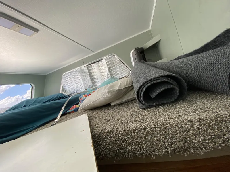 Slide: The Image of Interior of 1988 Three Buoys 4412, featuring a cozy carpeted sleeping area. - 27